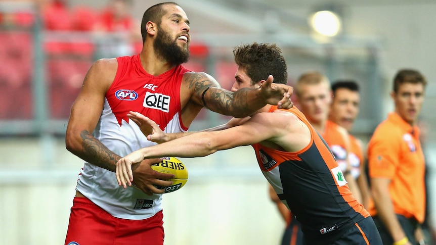 Sydney's Lance Franklin clashes with the Giants' Tomas Bugg in round one at Sydney Showground.