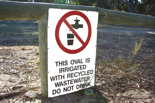 A sign saying waste water is used to irrigate an oval