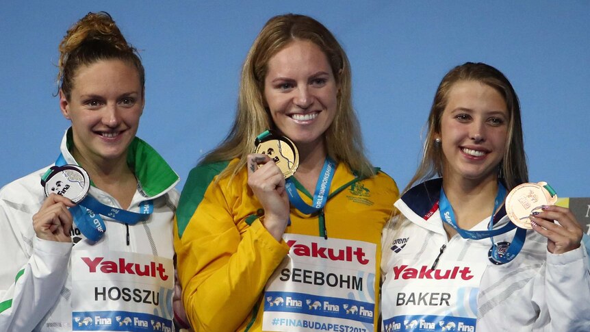 Katinka Hosszu (R), Emily Seebohm (C) and Kathleen Baker hold up their medals following the 200 metres backstroke final.
