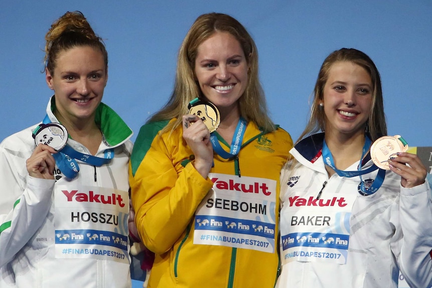 Katinka Hosszu (R), Emily Seebohm (C) and Kathleen Baker hold up their medals following the 200 metres backstroke final.