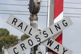 A man and a woman were killed when their ute drove through a train crossing.