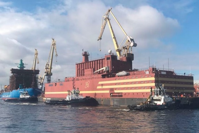 A ship being built with a crane on top