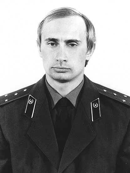 A black and white photo of a young Vladimir Putin in uniform