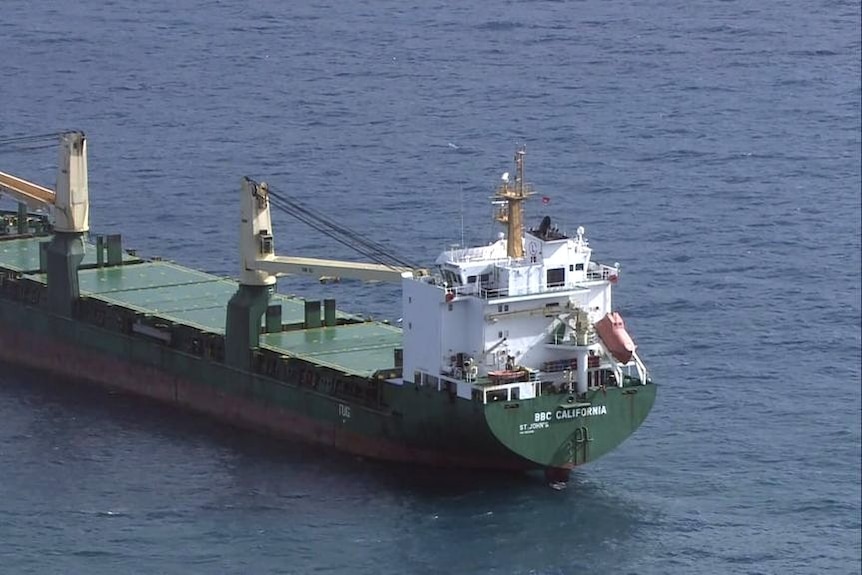 An aerial photo of a cargo ship on water. 