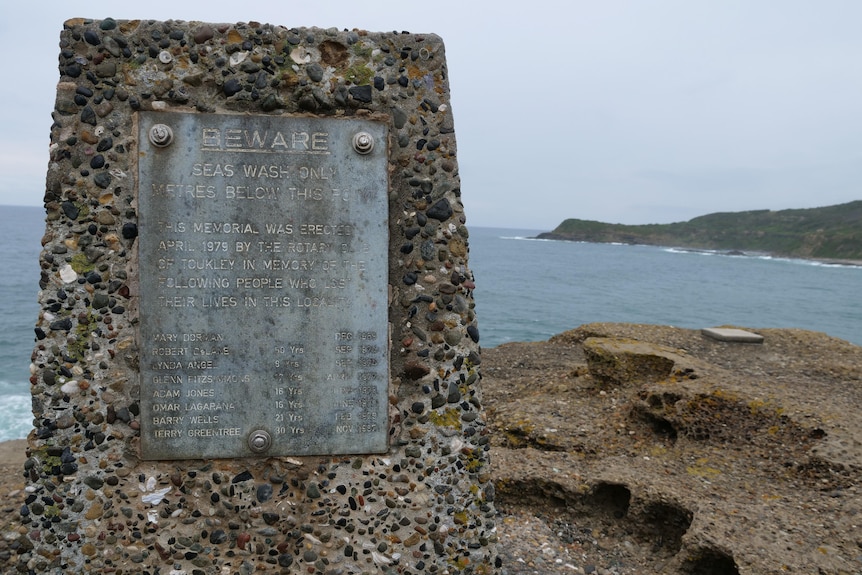 A memorial plaque on a concrete slab at Snapper Point