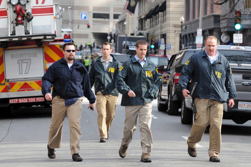 FBI agents arrive at the scene of explosions in Boston.