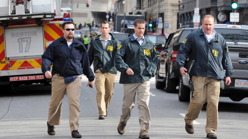 FBI agents arrive at the scene of explosions in Boston.