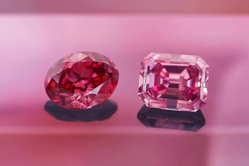 A close up of a pink and red diamond