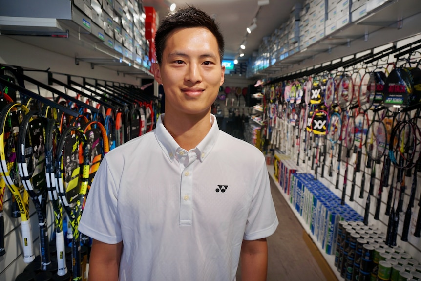 Man smiling standing in sporting goods store