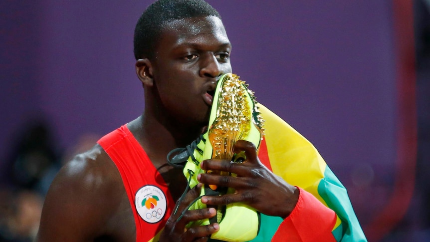 Kirani James kisses his running shoes after winning the men's 400m final.