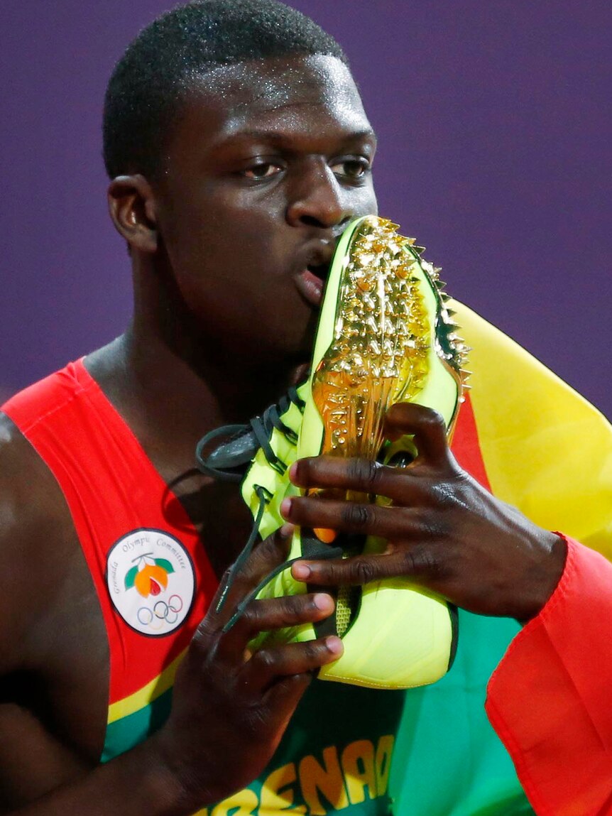 Kirani James kisses his running shoes after winning the men's 400m final.