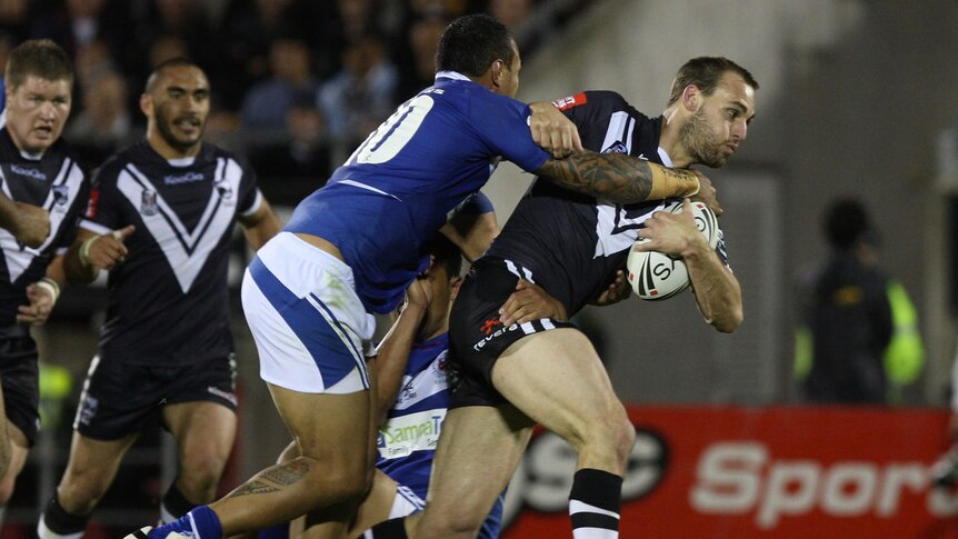 Simon Mannering charges the ball forward for the Kiwis.