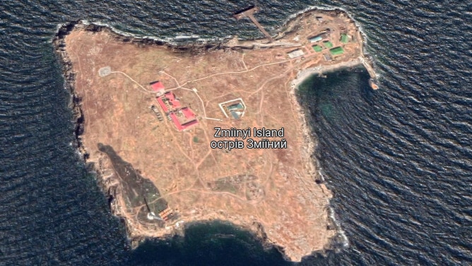 An annotated aerial image of a small island with a few buildings on it.