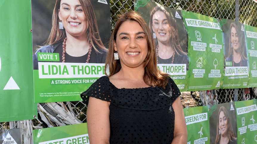 Greens Northcote candidate Lidia Thorpe hands out how-to-vote cards on election day.
