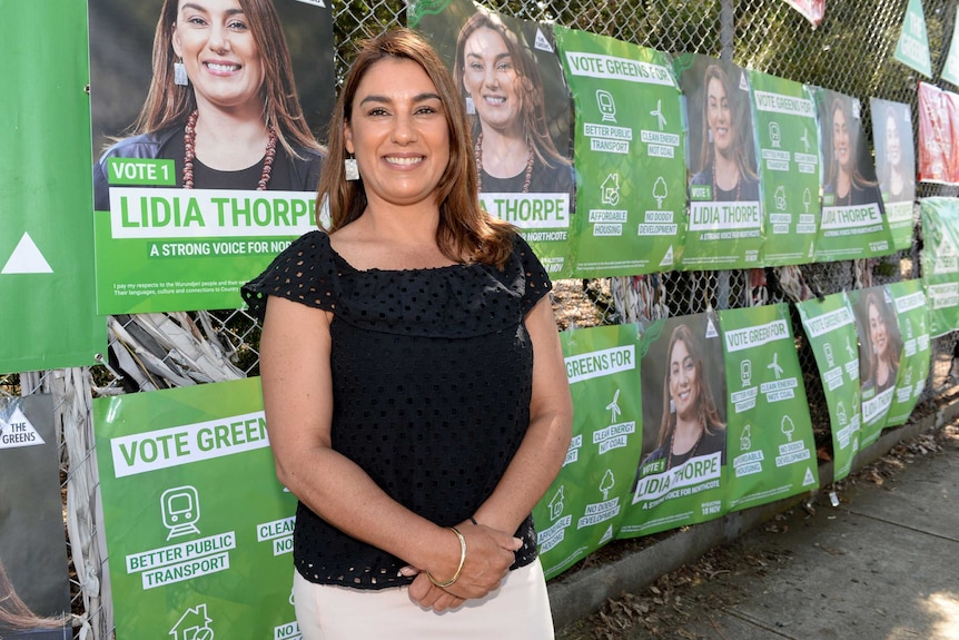Greens' Northcote candidate Lidia Thorpe hands out how-to-vote cards on election day.