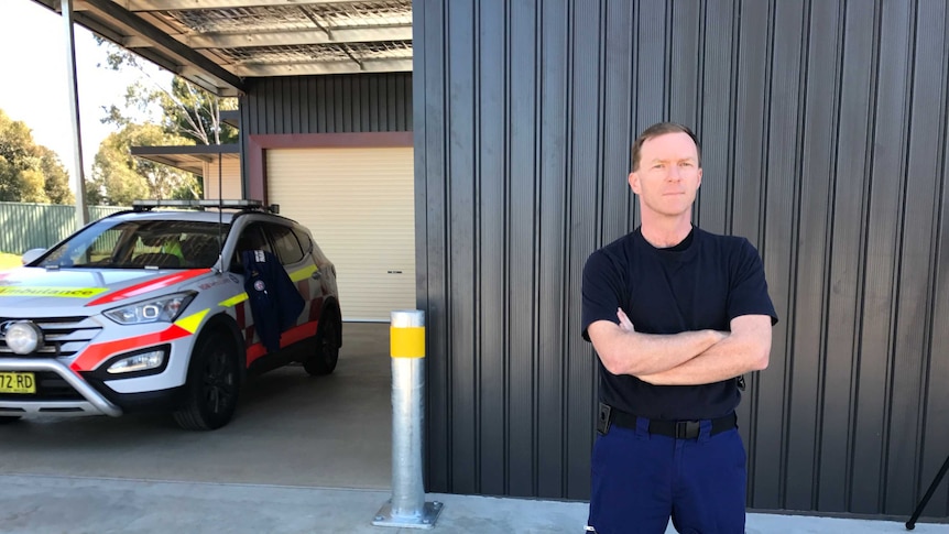 Head of the NSW Paramedics Association, Steve Pearce, crosses his arms standing in front of Coolamon ambulance station.