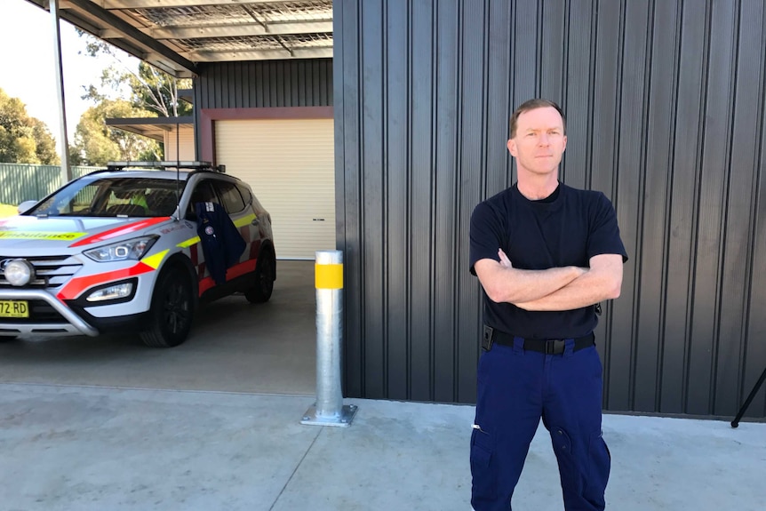 Head of the NSW Paramedics Association, Steve Pearce, crosses his arms standing in front of Coolamon ambulance station.