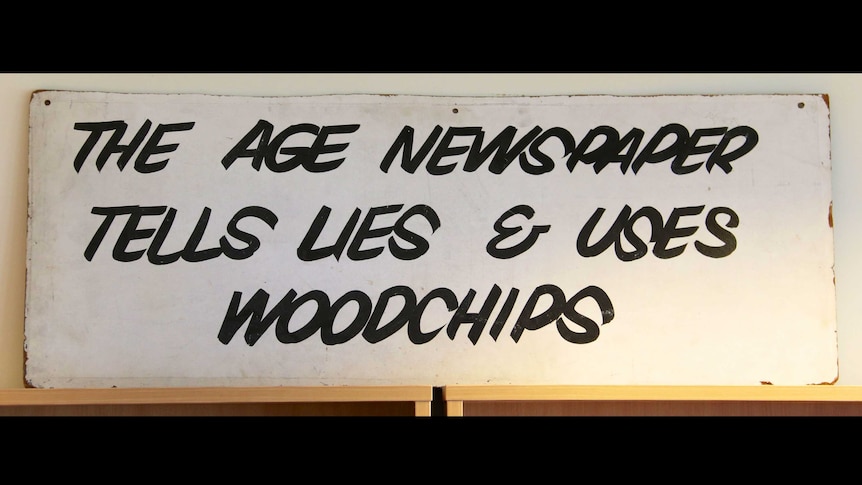 A poster in The Age office in Federal Parliament House which reads "The Age newspaper tells lies and uses woodchips"