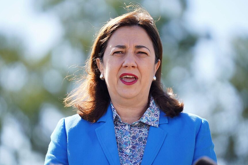 Headshot of Annastacia Palaszczuk wearing a blue blazer over a blue floral patterned collared shirt