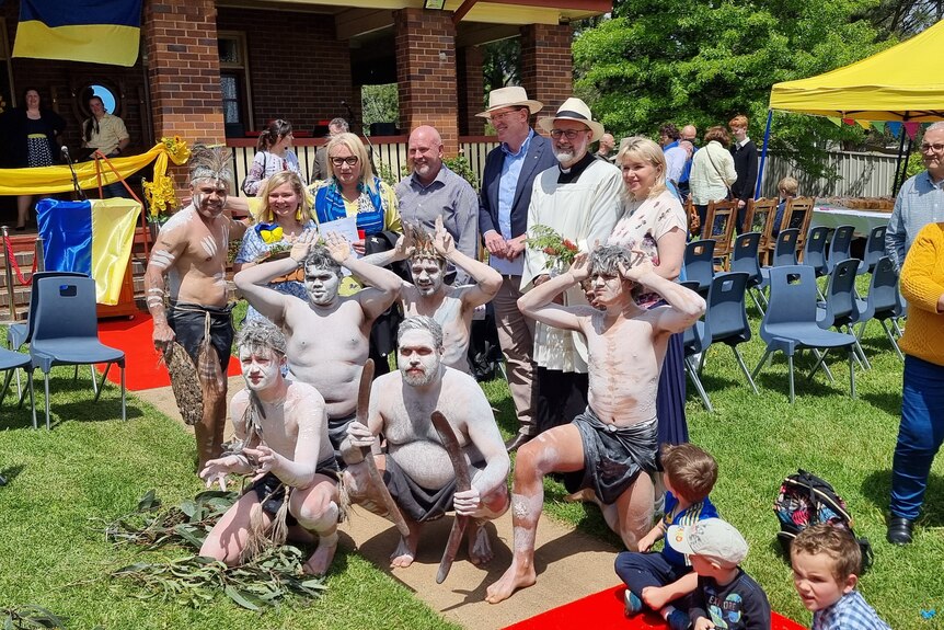 A group of Indigenous people taking a photo with a priest and other locals from Molong.