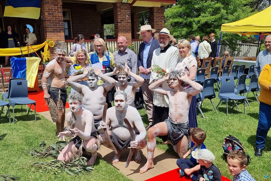 A group of Indigenous people taking a photo with a priest and other locals from Molong.
