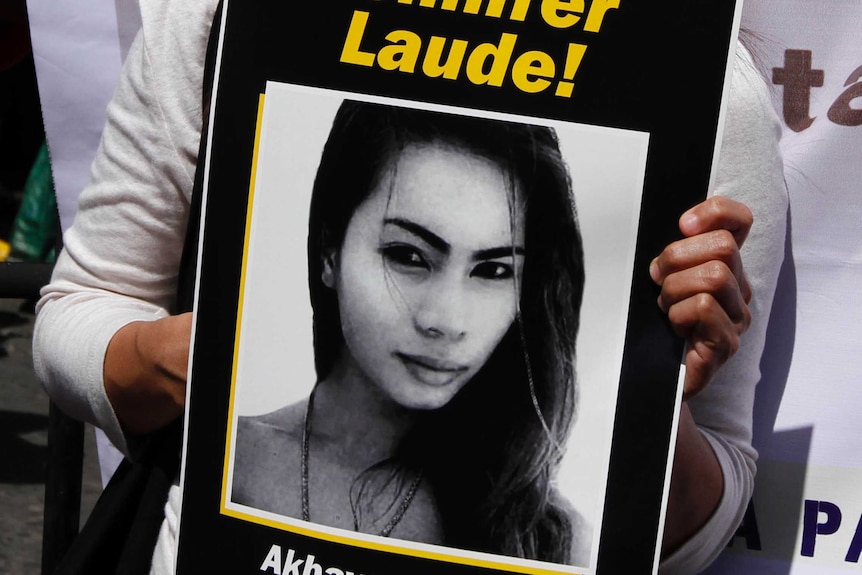 A protester holds a picture of transgender Filipino, Jennifer Laude.