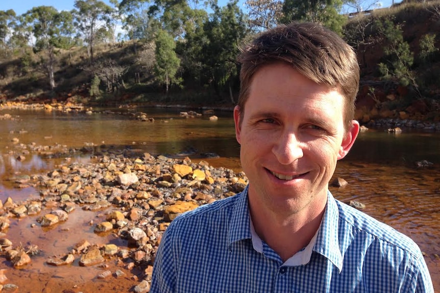 Dr Peter Erskine at the contaminated Dee River just outside the old Mount Morgan mine site