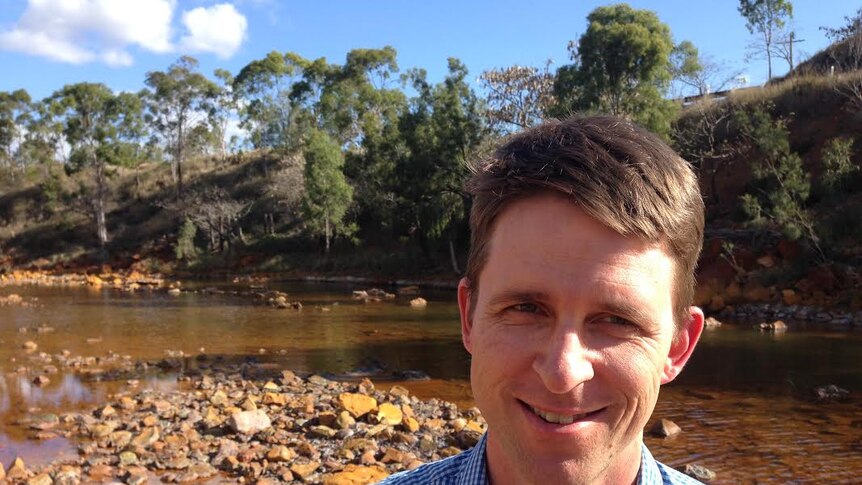 Dr Peter Erskine at the contaminated Dee River just outside the old Mount Morgan mine site