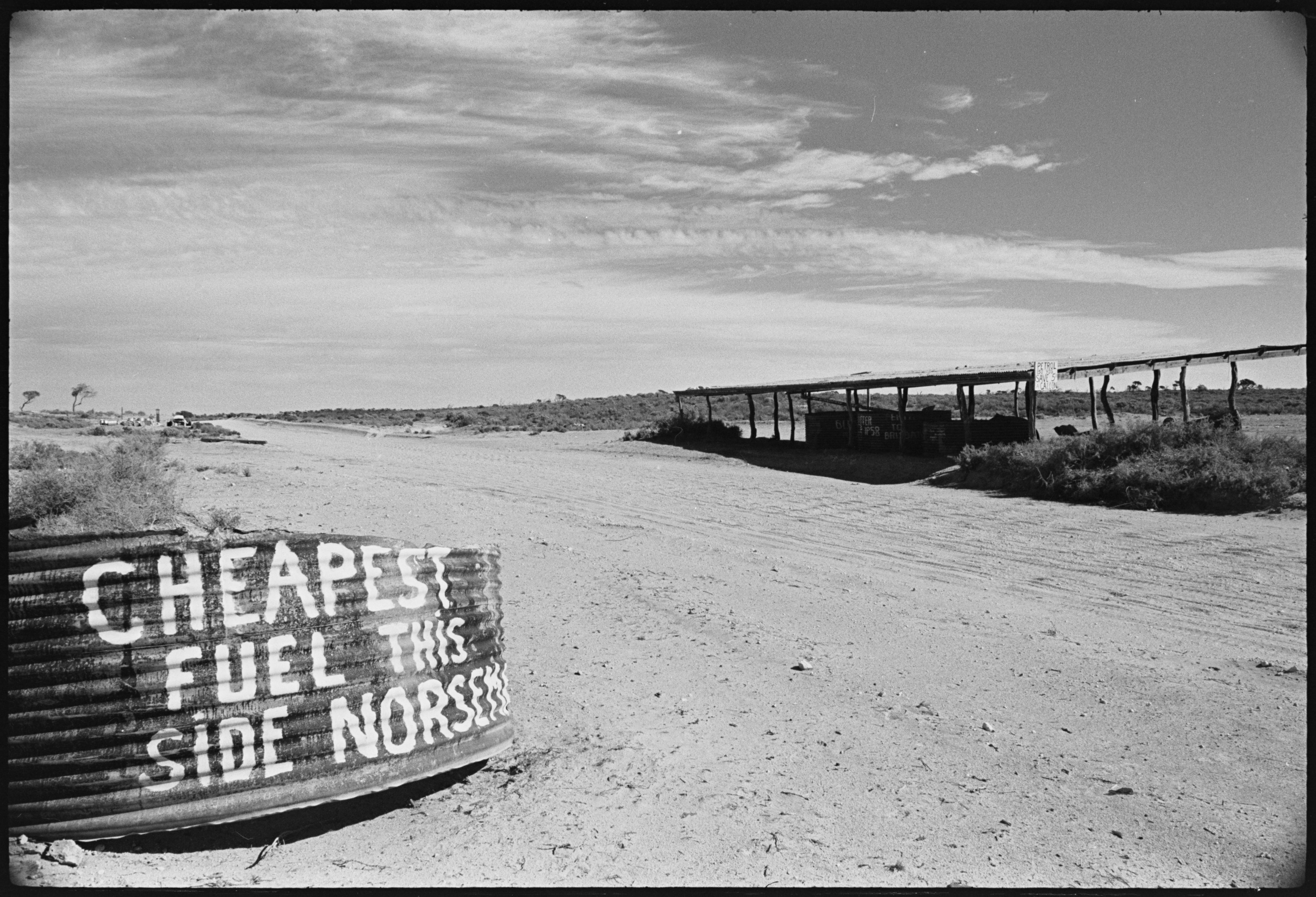A roadside fuel sign on the Nullarbor, beside the unsealed road