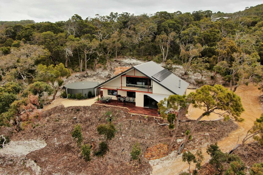 A drone photo of a house in the bush