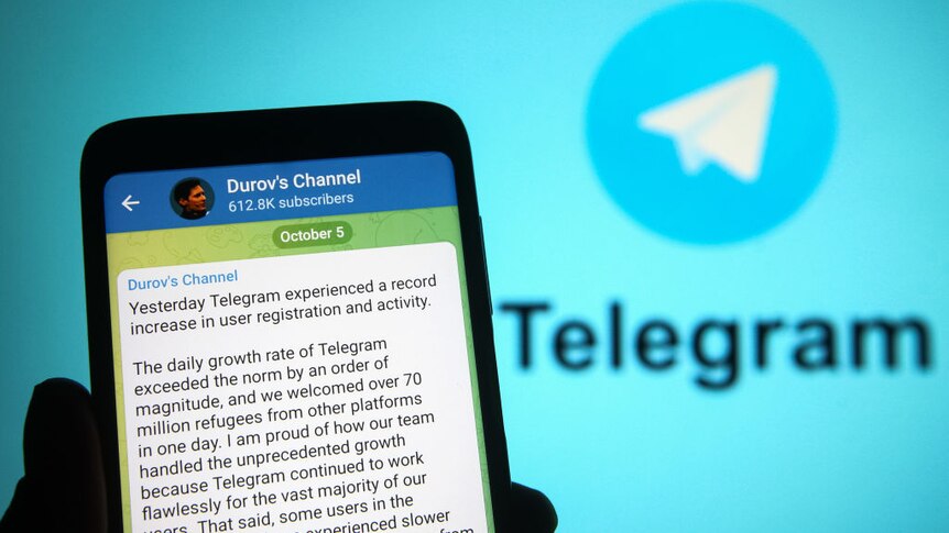 a photo of a phone with the Telegram app open and a message from its founder