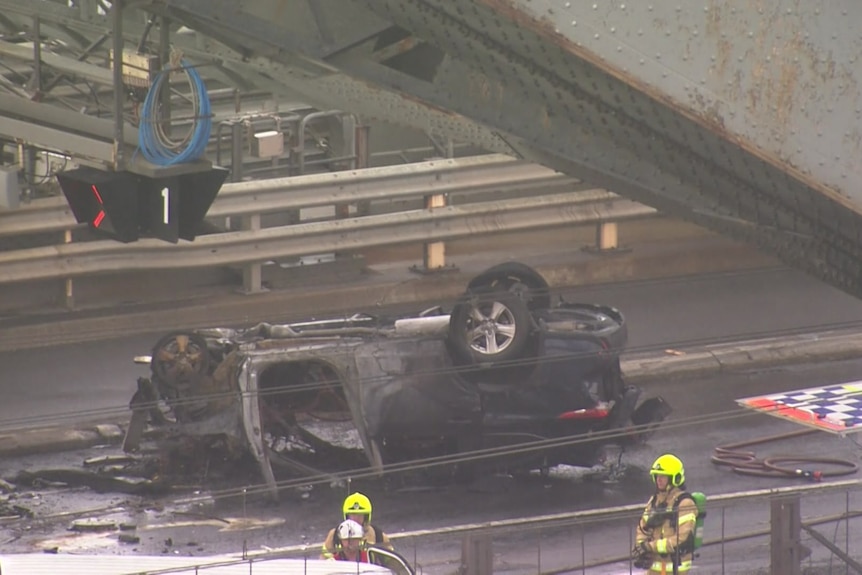 a burnt out car on its roof