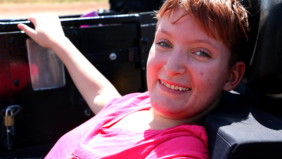 Katanning teenager Shanniah Barker smiles and looks at the camera sideways while sitting in a motorbike sidepod.