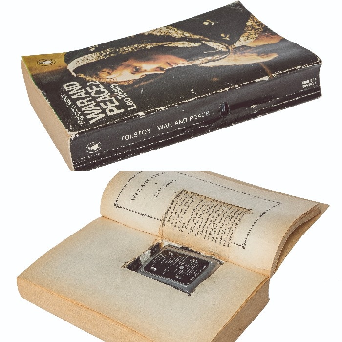 A copy of Tolstoy's War and Peace with the middle cut out of the pages, where a camera is hidden.