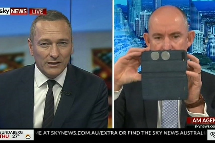 Mr Robert's face is obscured by his iPhone as Sky presenter Kieran Gilbert attempts to ask a question.