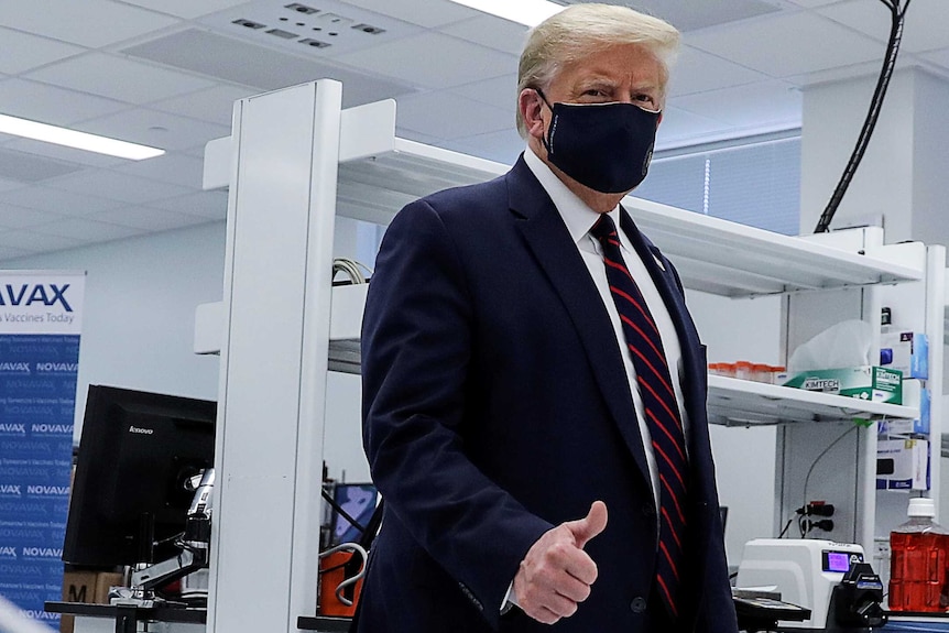 Donald Trump in a face mask giving a thumbs up