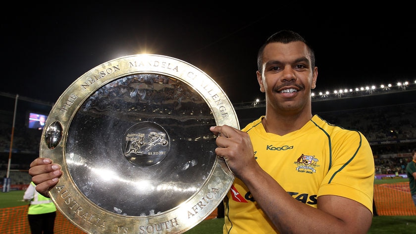 Man of the moment: Kurtley Beale holds the Nelson Mandela Challenge Trophy after sinking the Springboks.