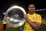Man of the moment: Kurtley Beale holds the Nelson Mandela Challenge Trophy after sinking the Springboks.