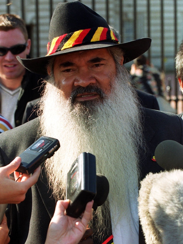 Patrick Dodson in his signature hat speaks to media