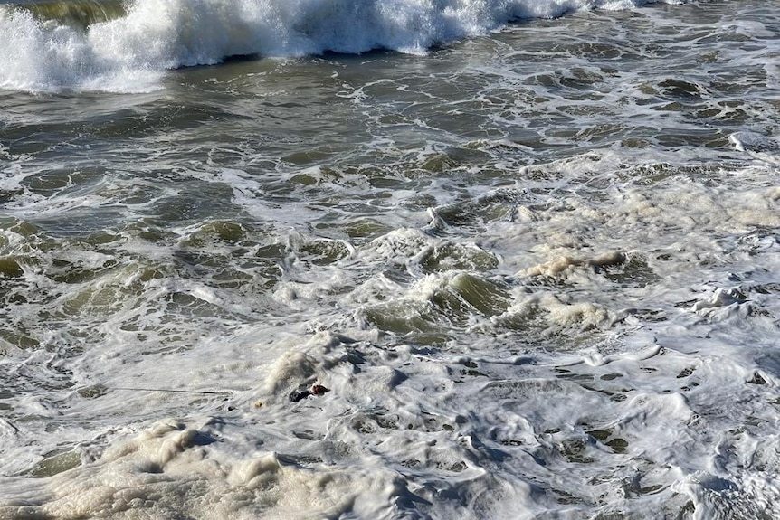 man in frothy water