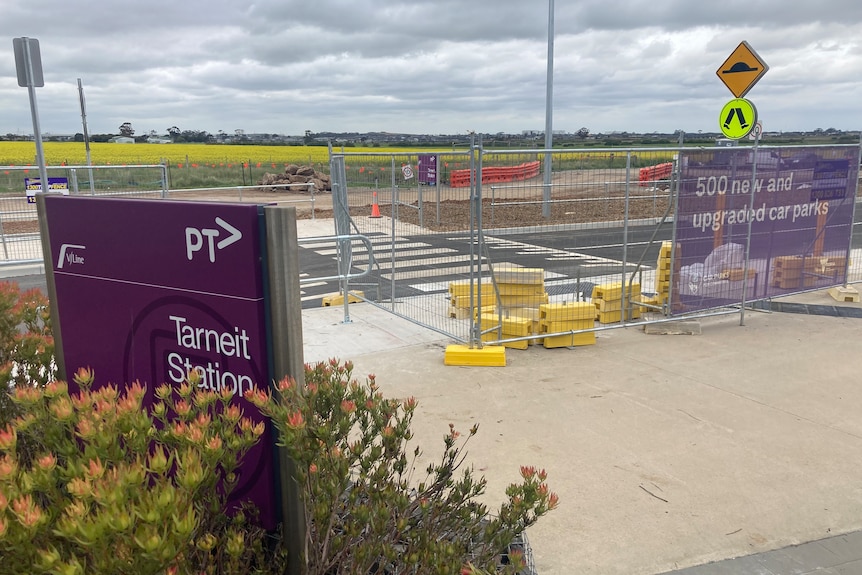 A train station with construction barriers in view