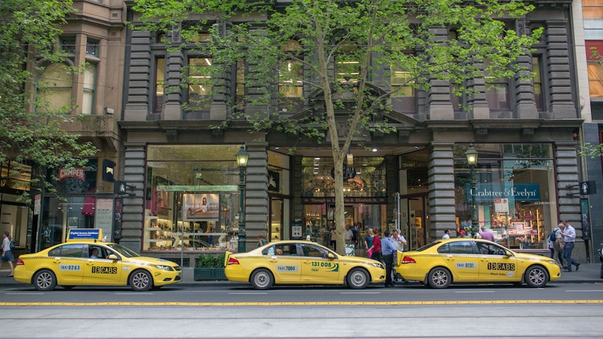 Drivers wait for customers at a taxi rank in Collins Street, Melbourne.