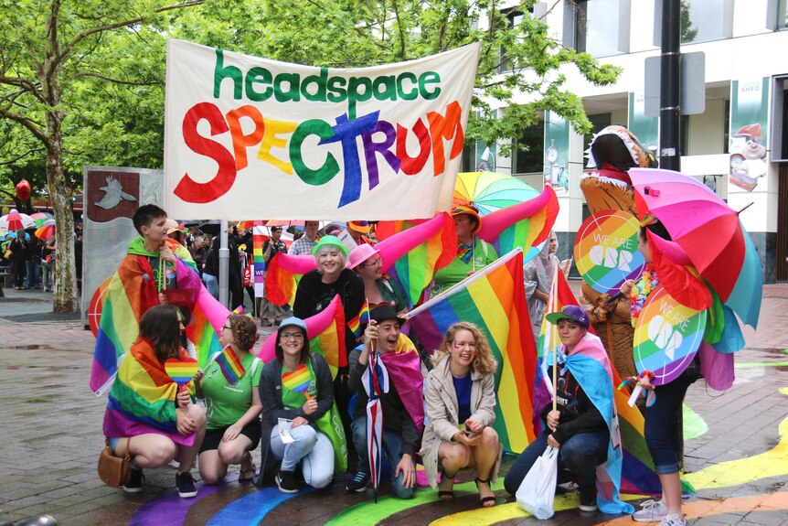 A group of people from Headspace wearing rainbow colours for the Spring Out Pride Parade.
