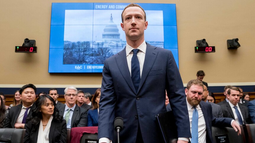 Facebook CEO Mark Zuckerberg arrives to testify on Capitol Hill. He is wearing a blue suit.