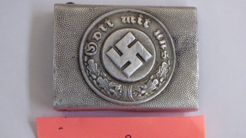 A badge with a swastika on it