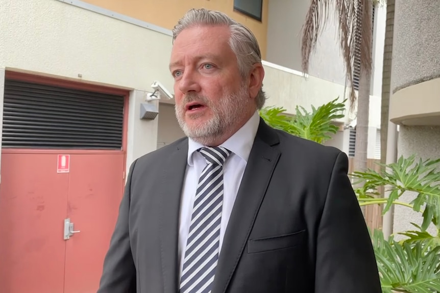 Man in suit, speaking