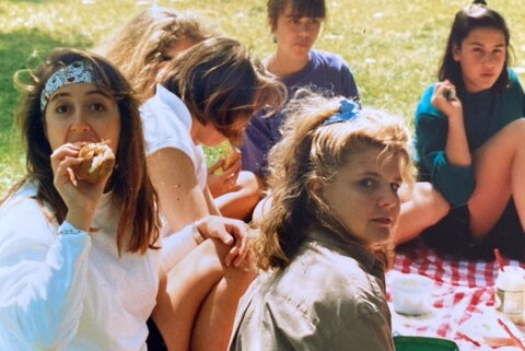 A group of teenage girls picnic in a park