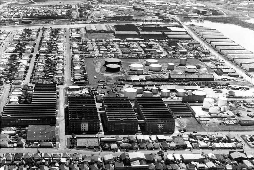 A black and white aerial photo of an industrial complex.