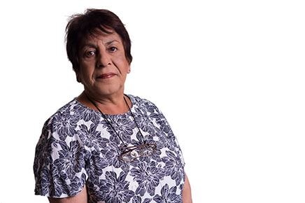 A woman with short brown hair looking at the camera.