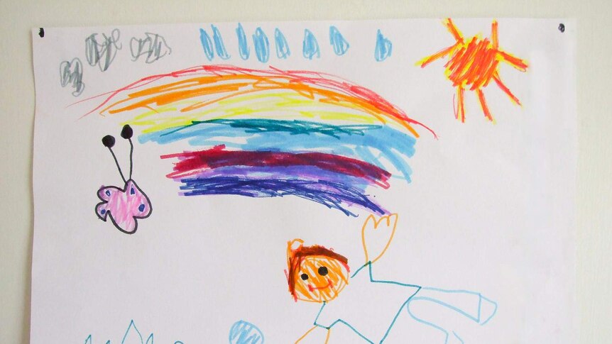 A child's drawing of a person with a rainbow and butterfly.